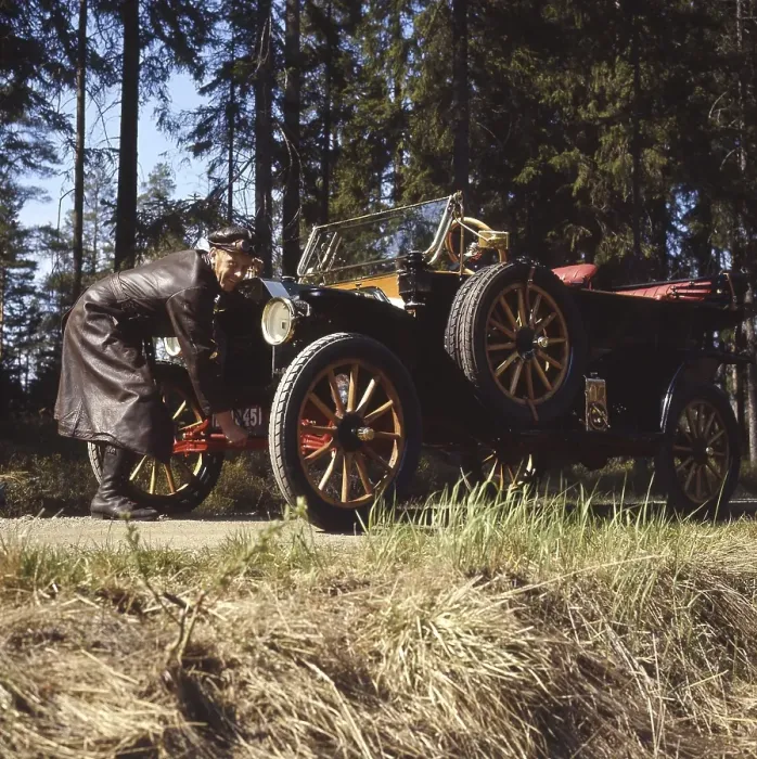Framed Print : The old car. A man in a typical old fashioned driver's outfit complete with a leather cap Framed Print : The old car. A man in a typical old fashioned driver's outfit complete with a leather cap