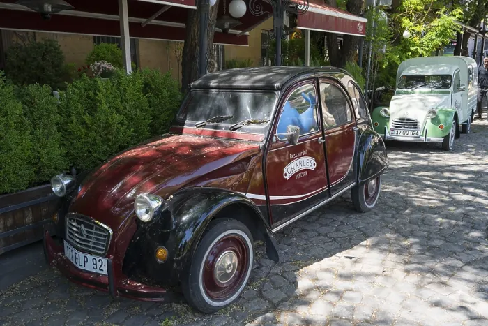 Framed Print : Two old Citroen cars are parked on a shady road