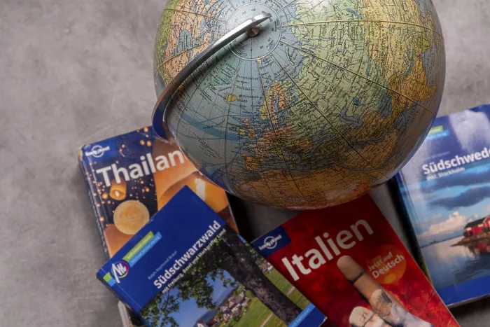 Framed Print : An old-fashioned globe next to travel guides for Thailand Framed Print : An old-fashioned globe next to travel guides for Thailand