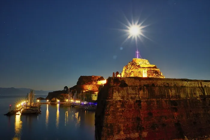 Framed Print : Old fortress, illuminated fortress at night with cross and starry sky over quiet harbor