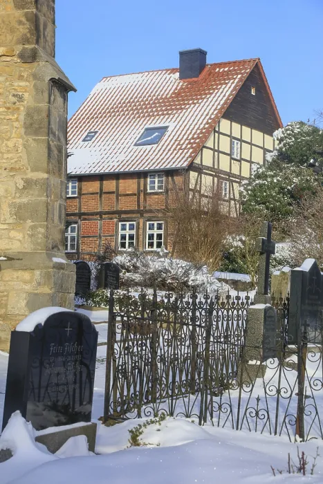 Framed Print : Old half-timbered house, historic cemetery at St