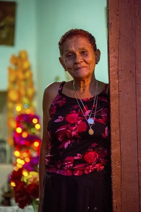 Framed Print : Old lady looks friendly out of her front door