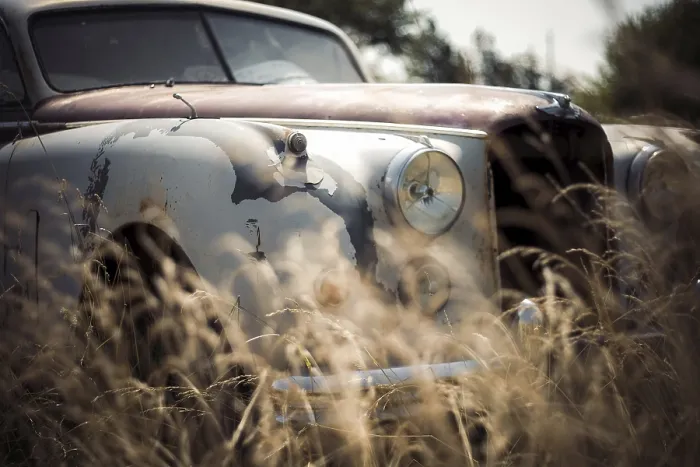 Framed Print : An old, rusted Jaguar car with overgrown grass Framed Print : An old, rusted Jaguar car with overgrown grass