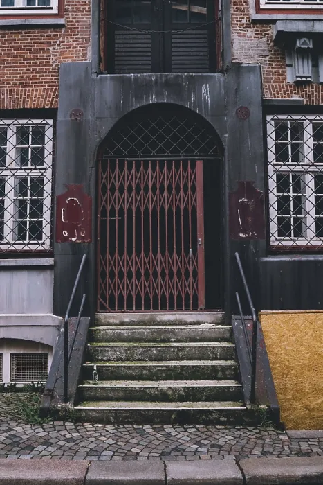 Framed Print : Old stone steps leading to an arched doorway with a red security gate in Hamburg Framed Print : Old stone steps leading to an arched doorway with a red security gate in Hamburg