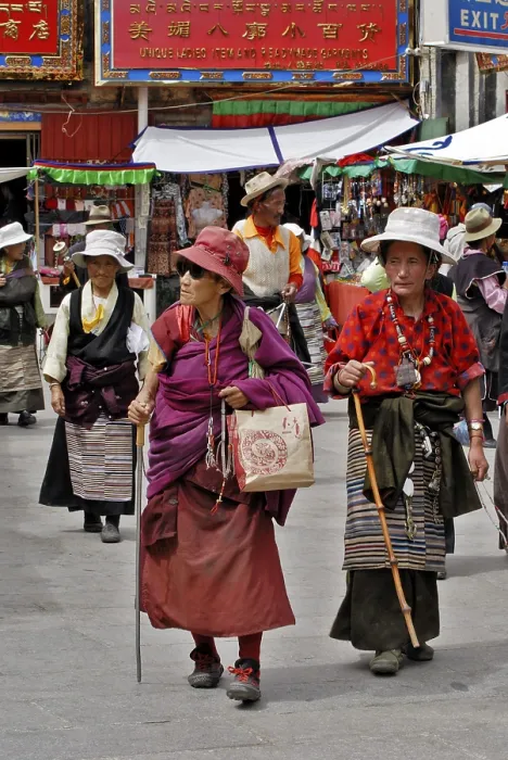 Framed Print : Old Tibetan women with prayer cords walk on the Barkor street