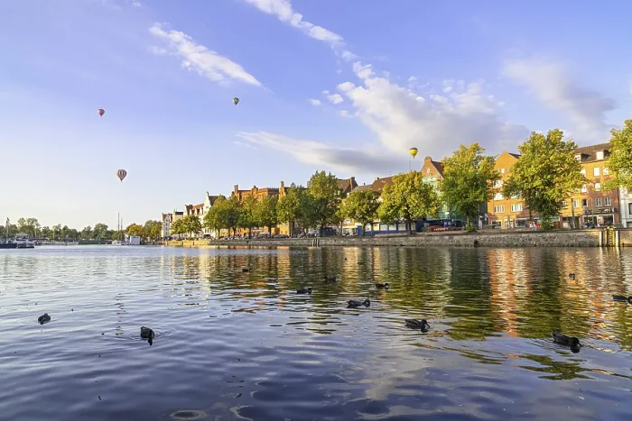 Framed Print : The Old Town of Lubeck, Germany with ducks in the river and balloons in the sky