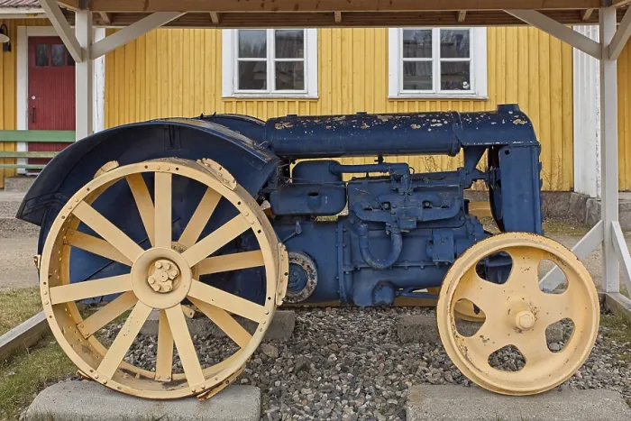 Framed Print : An old tractor restored and painted blue and yellow and put on display Framed Print : An old tractor restored and painted blue and yellow and put on display