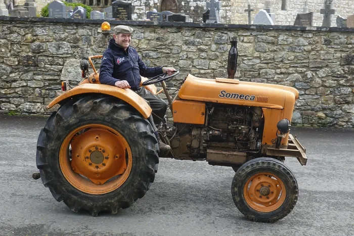 Framed Print : Old tractor Someca in front of church and chapel Sainte Nonne