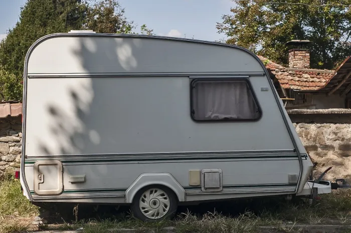 Framed Print : Old vintage caravan side view closeup at country house in sunny day