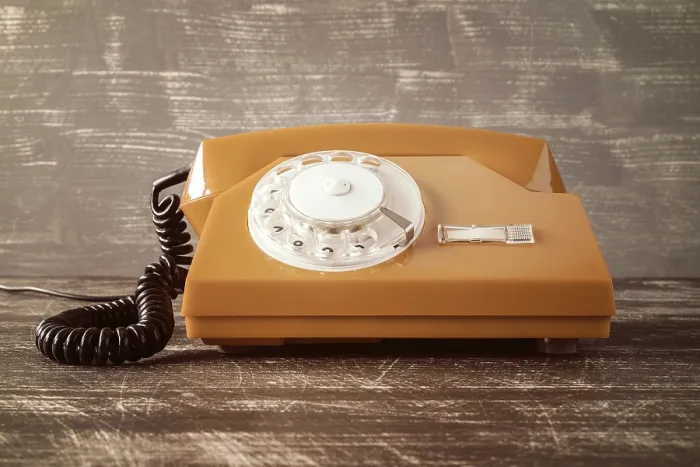 Framed Print : Old vintage classic telephone on wooden table