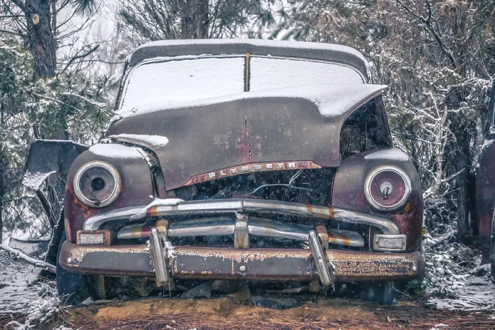 Framed Print : Old vintage plymouth automobile in the woods covered in snow