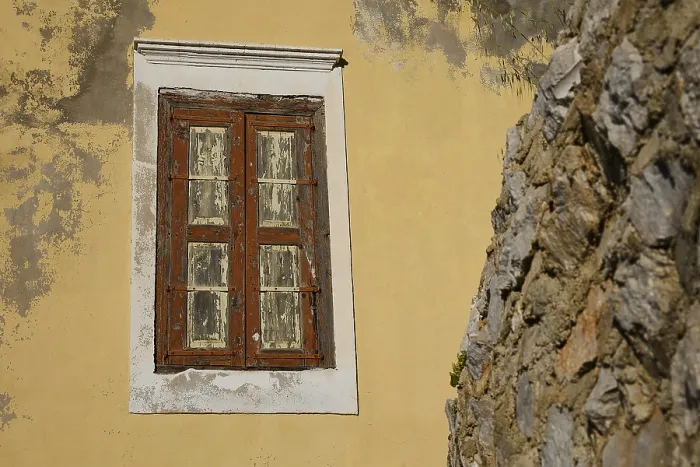 Framed Print : An old, weathered window in a yellow wall