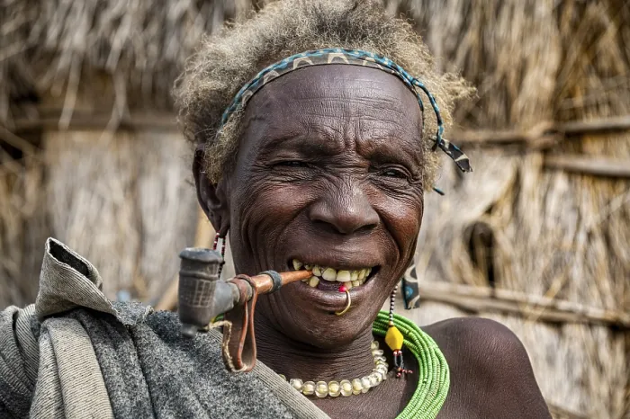 Framed Print : Old woman of the Jiye tribe smoking a pipe