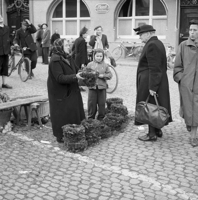 Framed Print : Older woman and boy sell flower wreaths