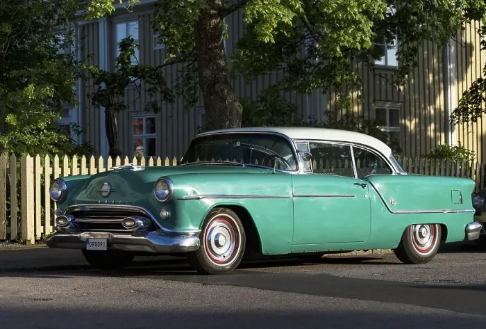 Framed Print : Oldsmobile 88 built in 1954, in front of Swedish wooden house