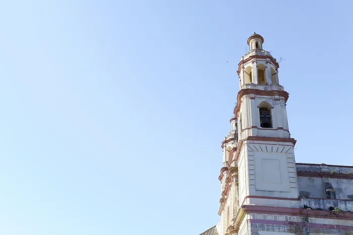 Framed Print : Olvera church bell tower rising against a clear blue sky in olvera