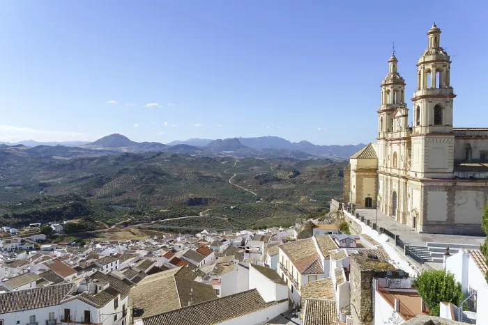 Framed Print : Olvera town perched on a hill, featuring its historic church and white houses