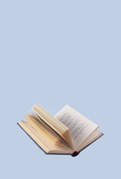 Framed Print : Open book in a blue cover on a blue background