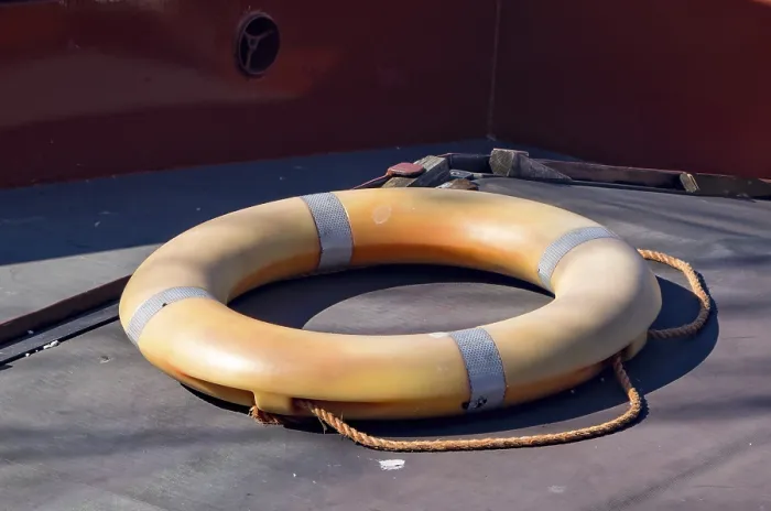 Framed Print : Orange lifebuoy with rope on deck of ship