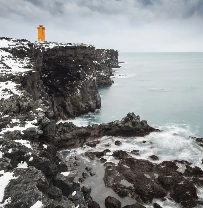 Framed Print : Orange lighthouse Oendverdarnes stands on a dark cliff