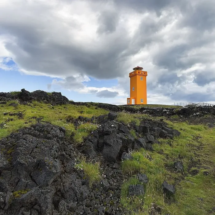 Framed Print : Orange lighthouse Skalasnagaviti or Svoertuloft at cliff