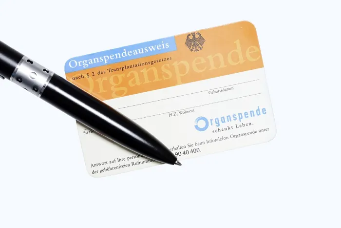 Framed Print : Organ donor card with biros on white background