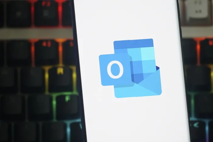 Framed Print : Outlook logo displayed on a smartphone screen against a keyboard backdrop Framed Print : Outlook logo displayed on a smartphone screen against a keyboard backdrop