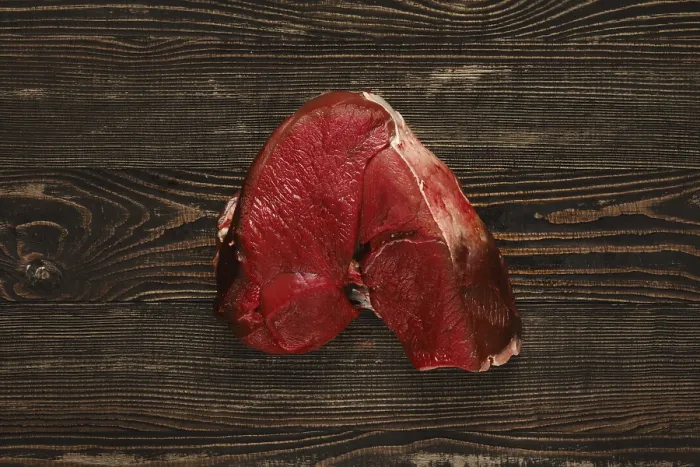 Framed Print : Overhead view of raw deer boneless ham over wooden background