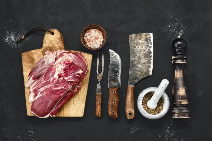 Framed Print : Overhead view of raw lamb shoulder without bone on wooden cutting board