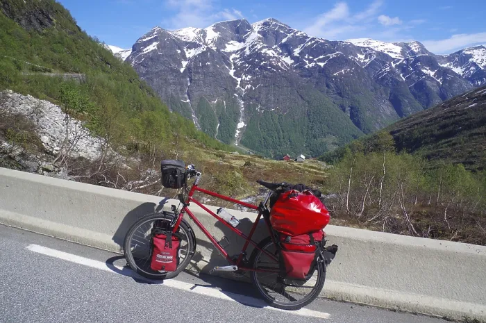 Framed Print : Packed bike on a road in front of snow-covered mountains Framed Print : Packed bike on a road in front of snow-covered mountains