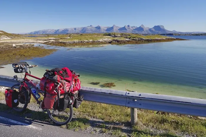 Framed Print : Packed touring bike, crystal clear water in a shallow bay