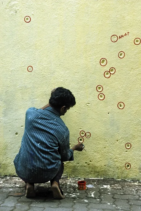 Framed Print : Painter encircle bullet marks on the wall Framed Print : Painter encircle bullet marks on the wall