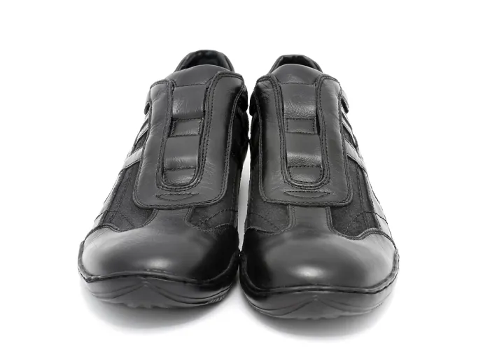 Framed Print : A pair of black mens sports shoes over white background