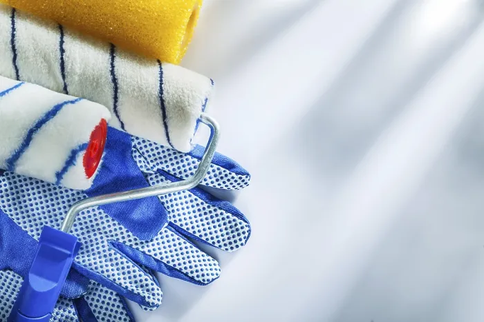 Framed Print : Pair of protective gloves paint rollers on white background
