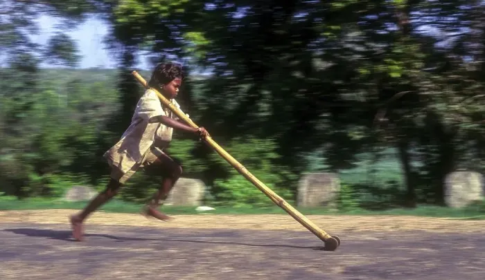 Framed Print : Panning, tribal boy playing improvised pulley in balle