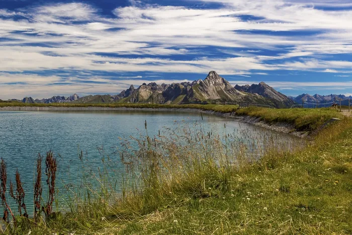 Framed Print : The panoramic lake at Saloberkopf with mountains in the background under a blue sky Framed Print : The panoramic lake at Saloberkopf with mountains in the background under a blue sky