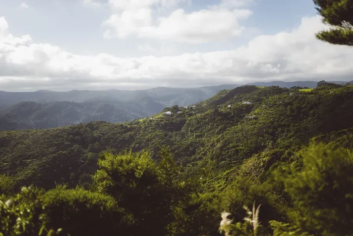 Framed Print : Panoramic shot of green mountains with deep valleys on a cloudy day under a blue sky