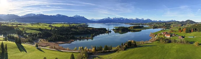 Framed Print : Panoramic view of a green landscape with lake and mountains under a clear sky Framed Print : Panoramic view of a green landscape with lake and mountains under a clear sky