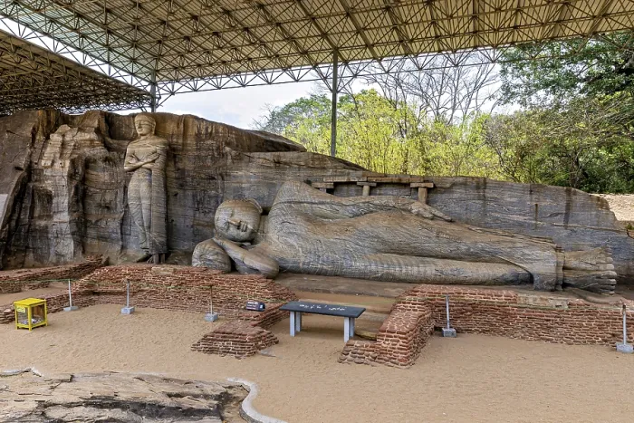 Framed Print : Panoramic view of a large reclining Buddha statue with a figure standing next to it under a protective canopy Framed Print : Panoramic view of a large reclining Buddha statue with a figure standing next to it under a protective canopy