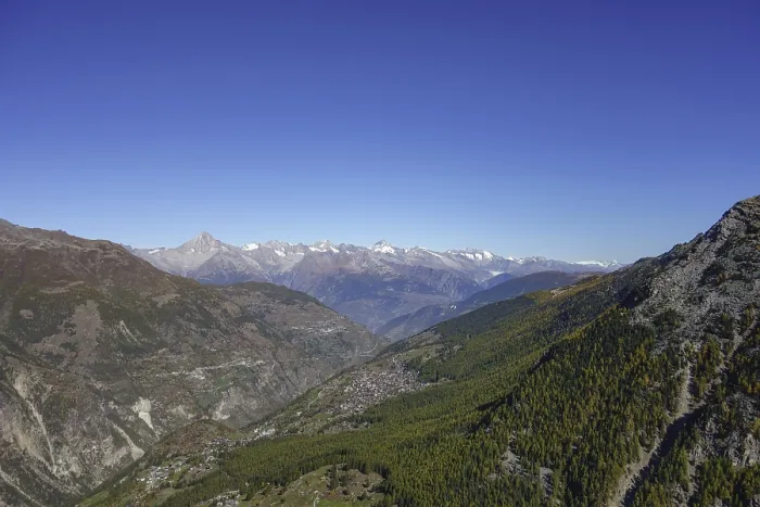 Framed Print : Panoramic view of a valley with mountains and forest under a clear sky