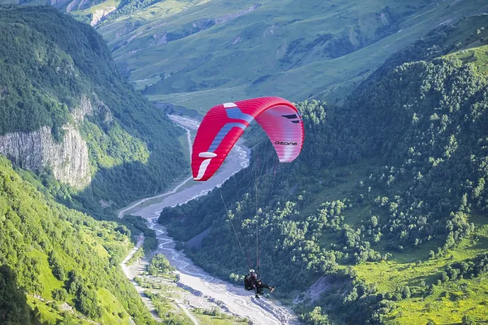 Framed Print : A paraglider floats over a narrow