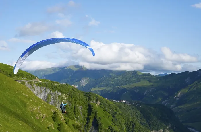 Framed Print : Paraglider flying with blue sky and mountain scenery Framed Print : Paraglider flying with blue sky and mountain scenery
