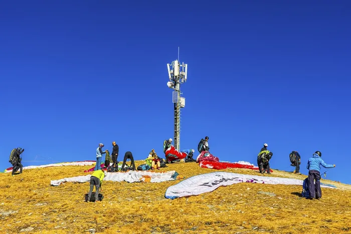 Framed Print : Paragliders prepare for takeoff below the transmitter and cell phone tower Framed Print : Paragliders prepare for takeoff below the transmitter and cell phone tower