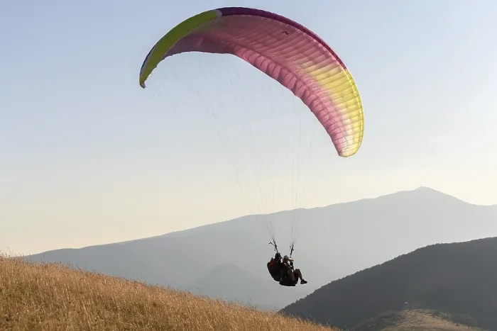 Framed Print : Paragliding flight in the air over the mountains