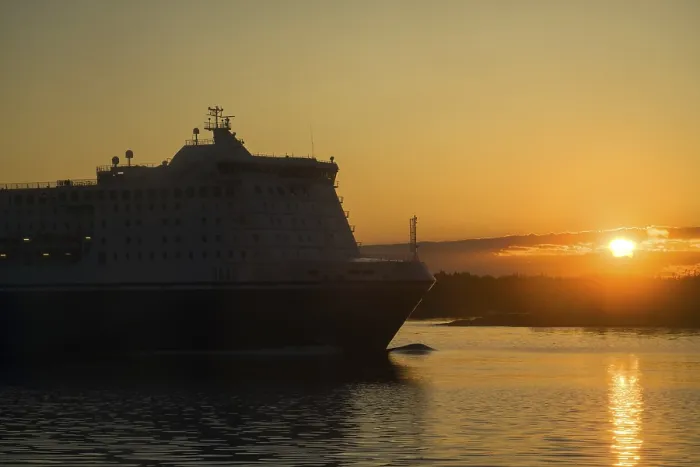 Framed Print : Passenger and freight ferry against a sunset in the Baltic sea