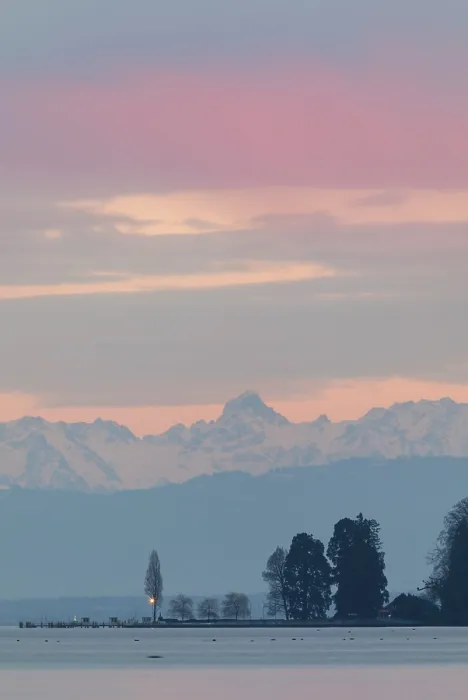 Framed Print : Pastel-colored sky over a lake and mountains in the distance