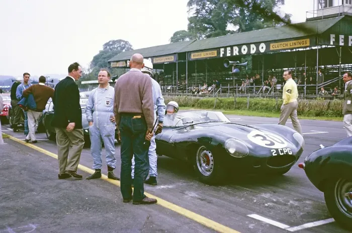 Framed Print : Pat Coundley in the car, John Coundley stands on the driver's side in blue overalls and looks into the camera, Jaguar D Type, Whitsun Sports Car Race in Goodwood, 3 June 1963 Framed Print : Pat Coundley in the car, John Coundley stands on the driver's side in blue overalls and looks into the camera, Jaguar D Type, Whitsun Sports Car Race in Goodwood, 3 June 1963