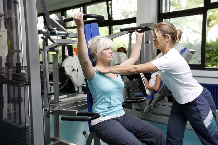Framed Print : Patients during muscle strength training on various machines in the training room