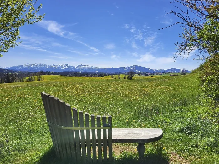 Framed Print : A peaceful landscape with a wooden bench in the foreground