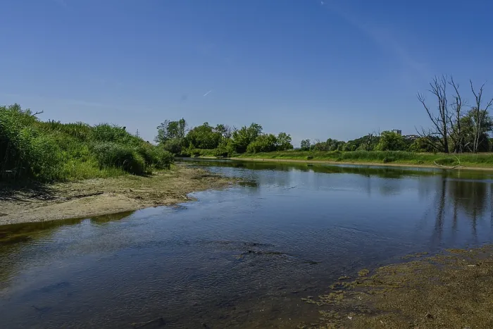 Framed Print : A peaceful river shines under a clear sky